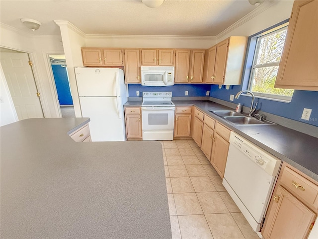 kitchen with dark countertops, white appliances, light brown cabinets, and a sink