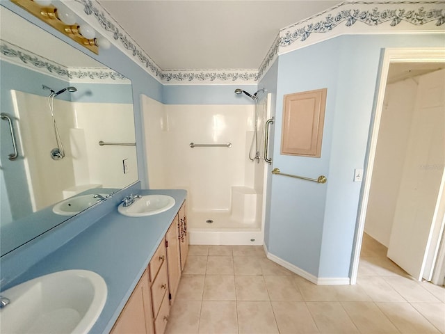 full bath with tile patterned flooring, a sink, and a shower stall