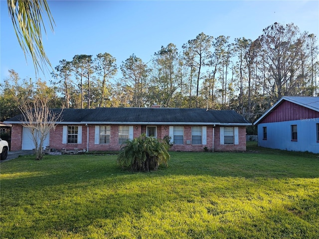 single story home featuring a garage and a front lawn