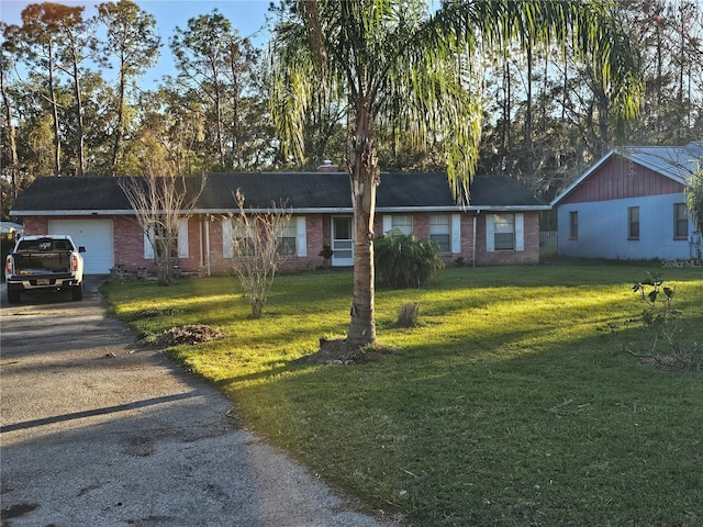 ranch-style house with a garage and a front yard