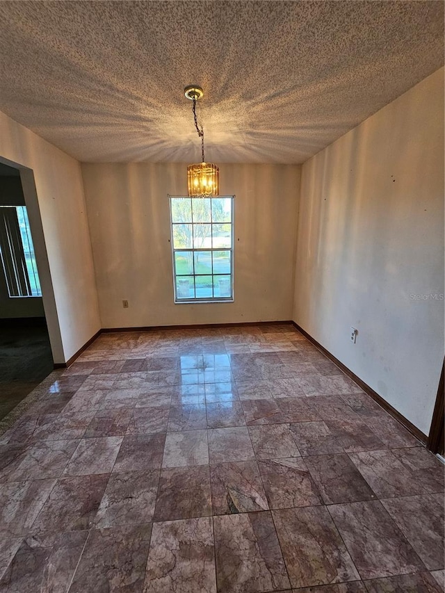 empty room featuring a notable chandelier