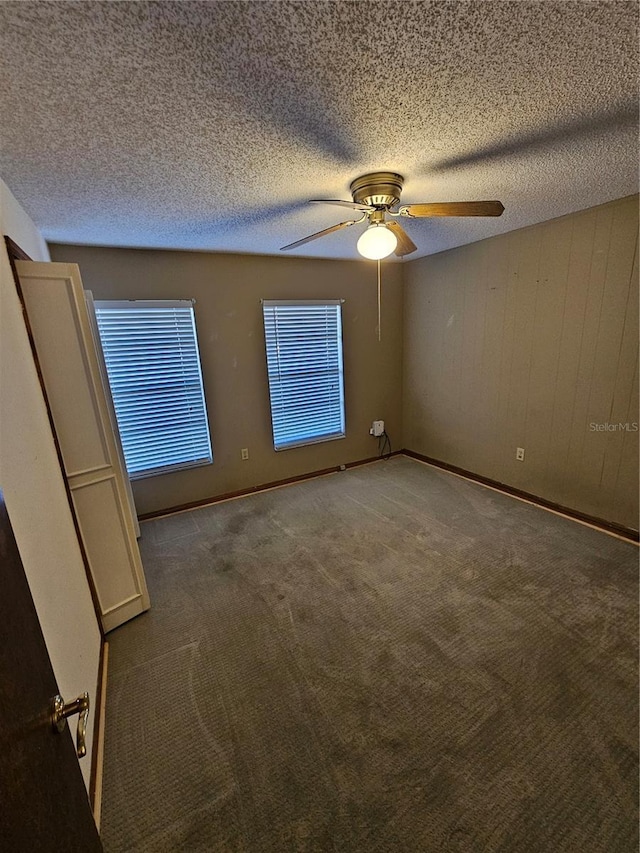 spare room with ceiling fan, carpet flooring, and a textured ceiling