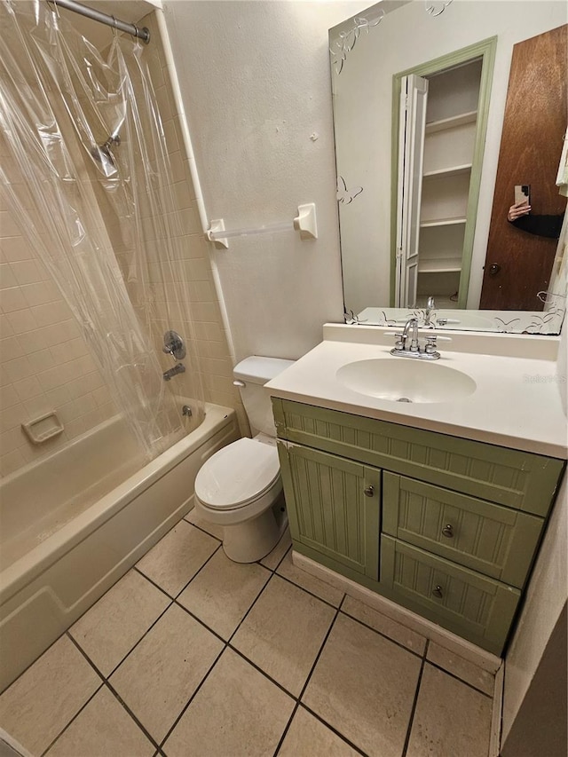 full bathroom with shower / tub combo with curtain, tile patterned floors, toilet, and vanity