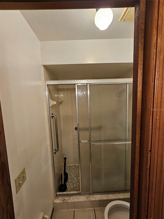 bathroom featuring tile patterned flooring and a shower with door