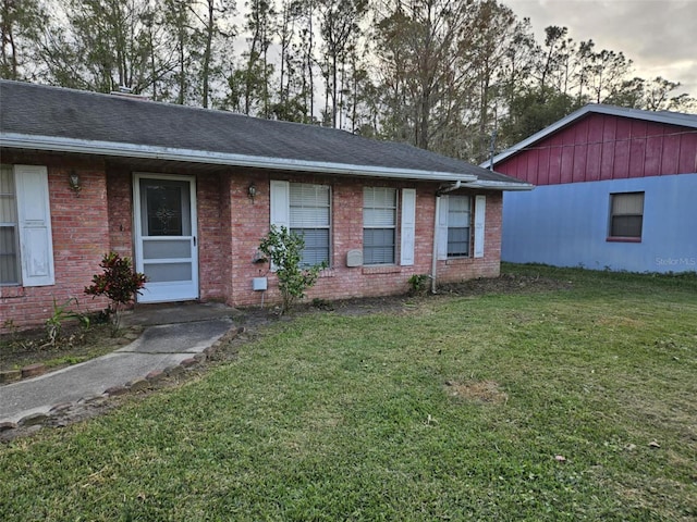 ranch-style home with a front lawn