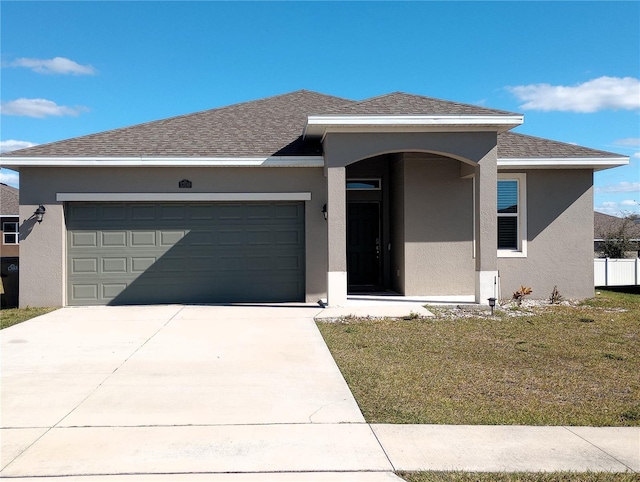 prairie-style home with a garage and a front yard