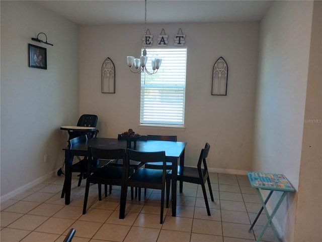 tiled dining room featuring an inviting chandelier