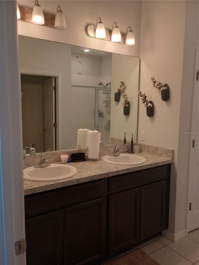 bathroom with an enclosed shower, vanity, and tile patterned floors