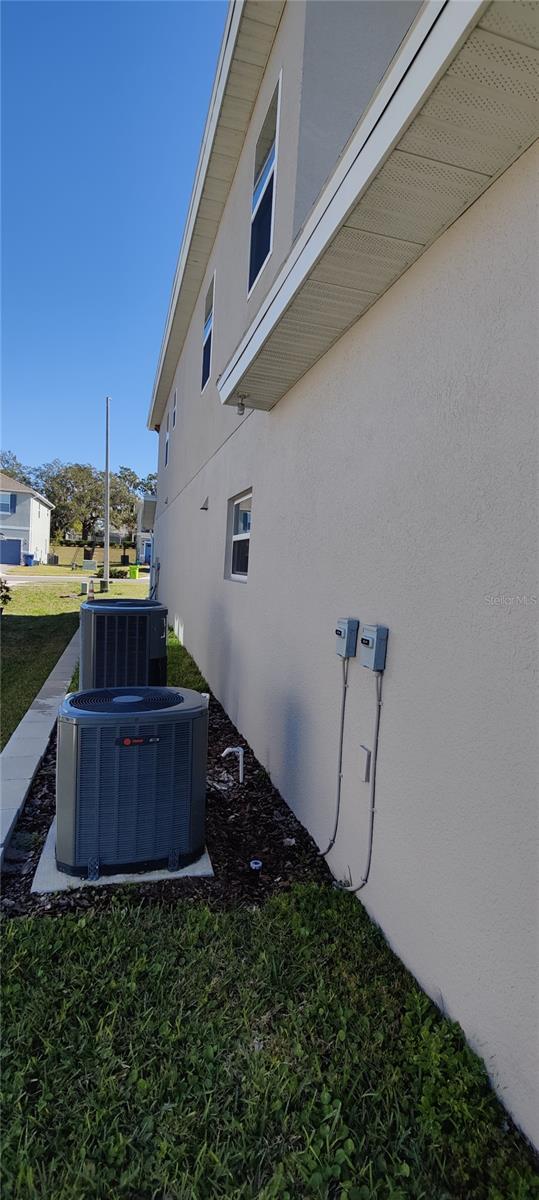 view of home's exterior featuring central AC unit and a yard