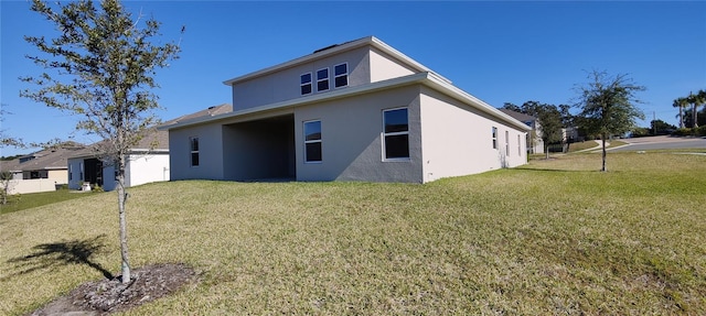 rear view of house featuring a yard