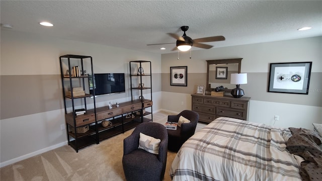 carpeted bedroom featuring a textured ceiling and ceiling fan