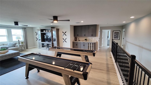 game room featuring light hardwood / wood-style flooring and ceiling fan