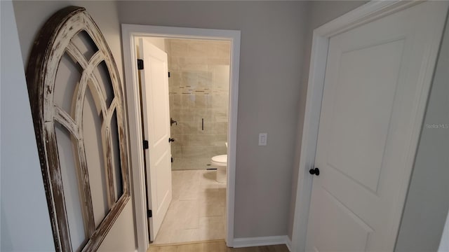 bathroom with an enclosed shower, tile patterned floors, and toilet