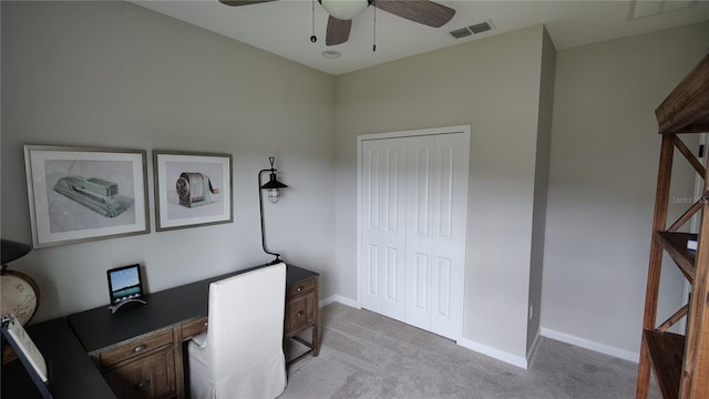 carpeted home office with ceiling fan