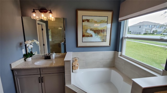 bathroom with vanity and independent shower and bath