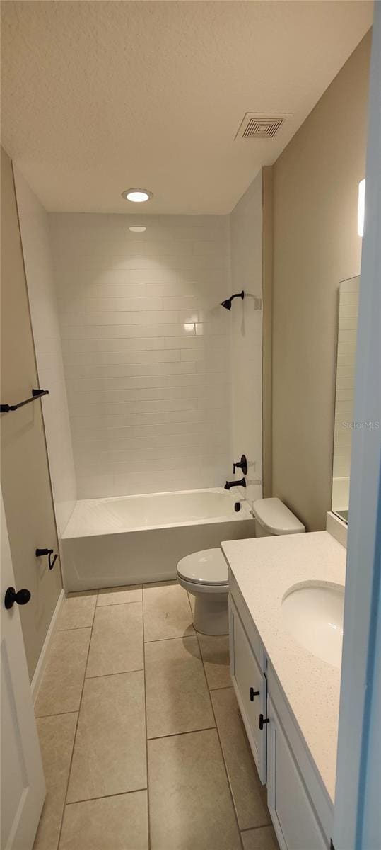 full bathroom with shower / bath combination, vanity, tile patterned flooring, and toilet