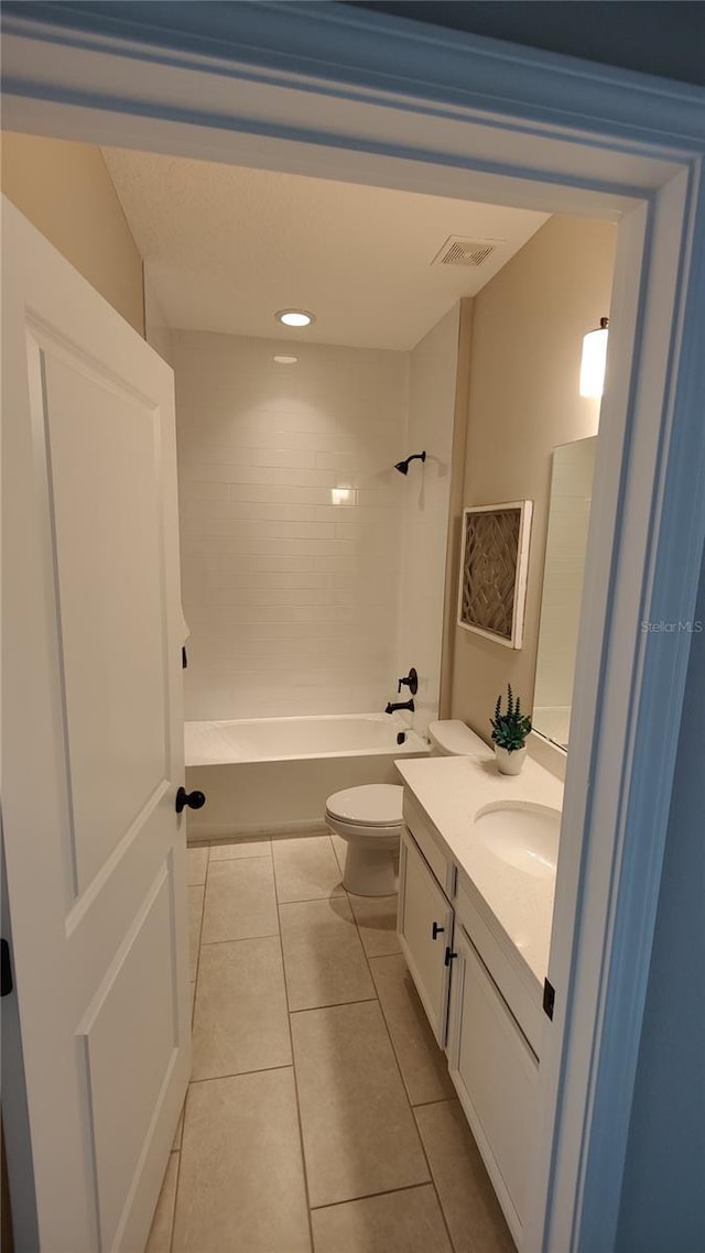 full bathroom with vanity, tile patterned floors, toilet, and washtub / shower combination