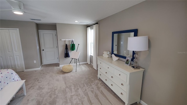 bedroom featuring light carpet, a closet, and ceiling fan