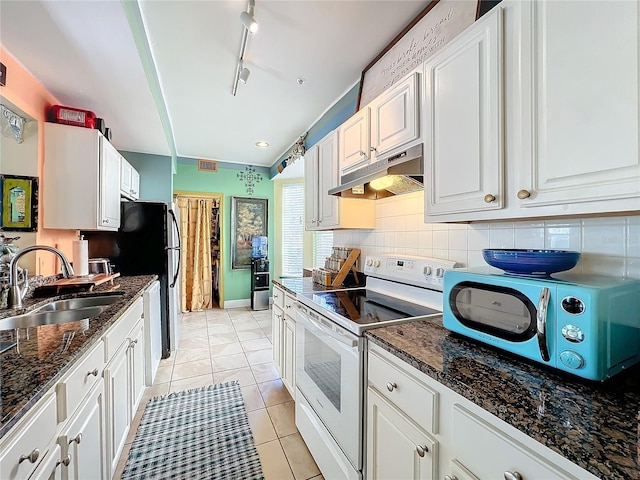 kitchen featuring sink, white cabinetry, light tile patterned floors, white range with electric cooktop, and decorative backsplash