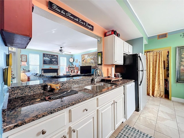 kitchen with sink, ceiling fan, white dishwasher, white cabinets, and light tile patterned flooring