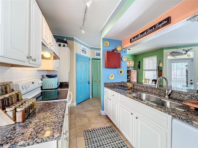 kitchen with white cabinetry, sink, white appliances, and decorative backsplash