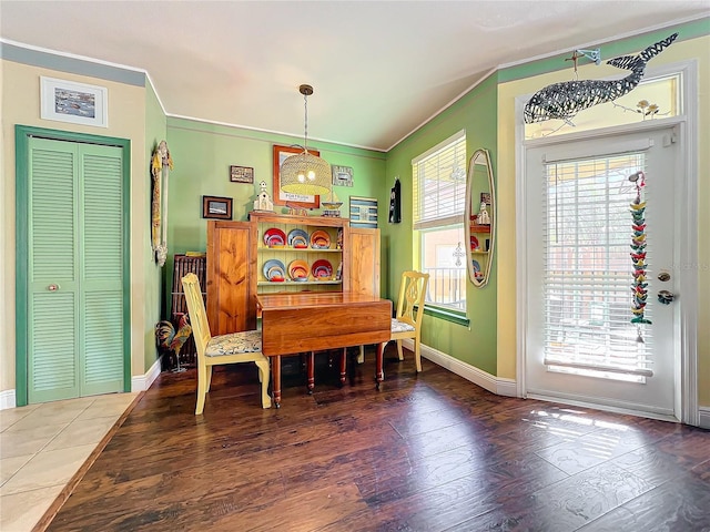 dining space with hardwood / wood-style flooring and ornamental molding