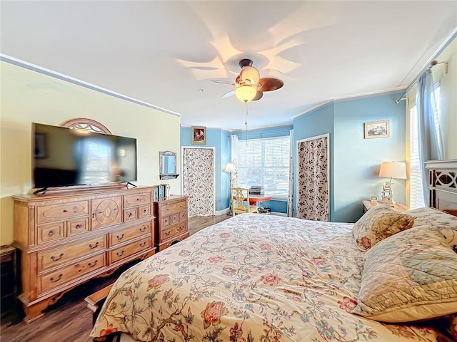 bedroom featuring wood-type flooring, ornamental molding, and ceiling fan