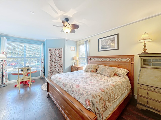 bedroom featuring crown molding, dark wood-type flooring, and ceiling fan