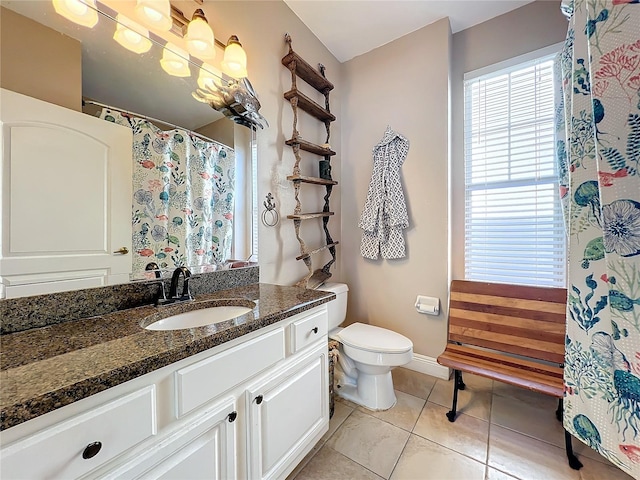 bathroom featuring vanity, toilet, and tile patterned flooring