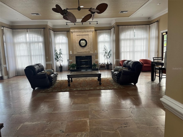 living room featuring crown molding, a large fireplace, and a textured ceiling