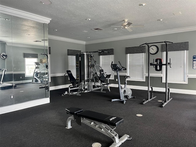 exercise room with ceiling fan, crown molding, and a textured ceiling