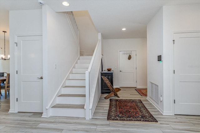 entrance foyer with a notable chandelier and light hardwood / wood-style floors