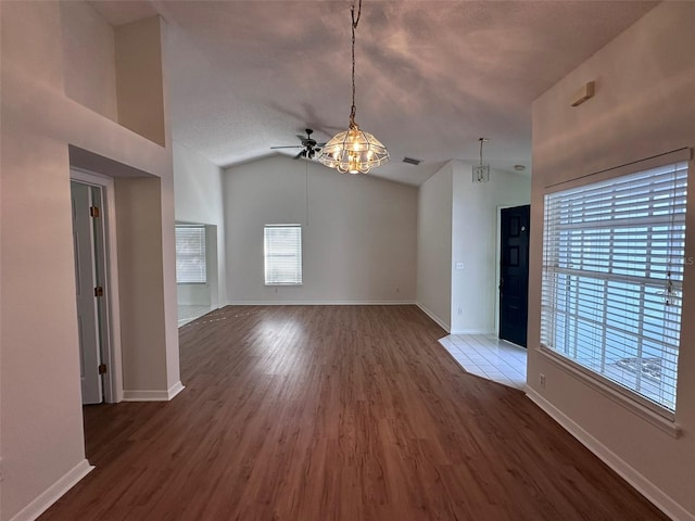 unfurnished living room featuring vaulted ceiling, hardwood / wood-style floors, and ceiling fan