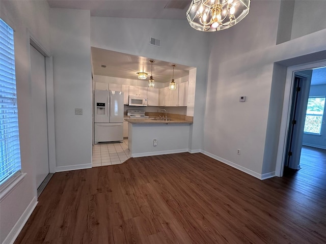 interior space with lofted ceiling, dark wood-type flooring, sink, and a notable chandelier