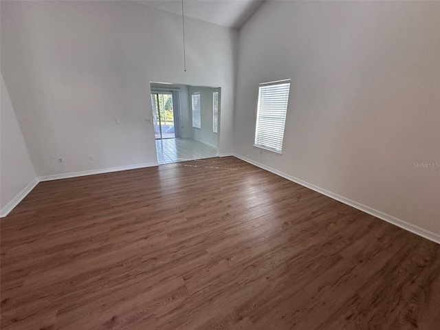 interior space featuring dark hardwood / wood-style flooring and high vaulted ceiling