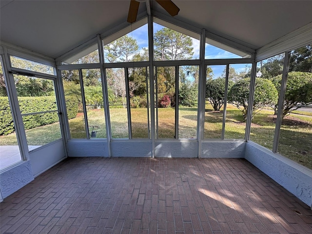 unfurnished sunroom featuring ceiling fan