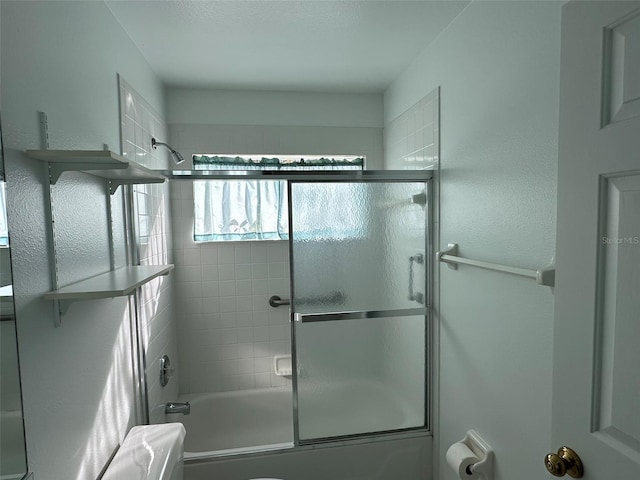 bathroom featuring shower / bath combination with glass door