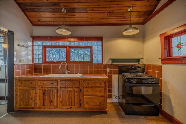 kitchen featuring decorative light fixtures, sink, tile counters, wood ceiling, and black gas stove