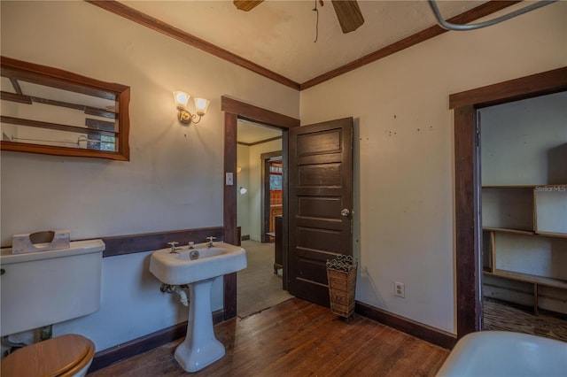 bathroom with ceiling fan, hardwood / wood-style flooring, ornamental molding, and toilet