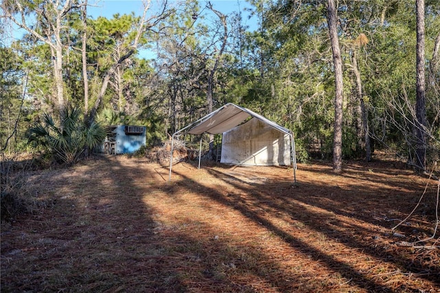 view of yard featuring a storage shed and a carport