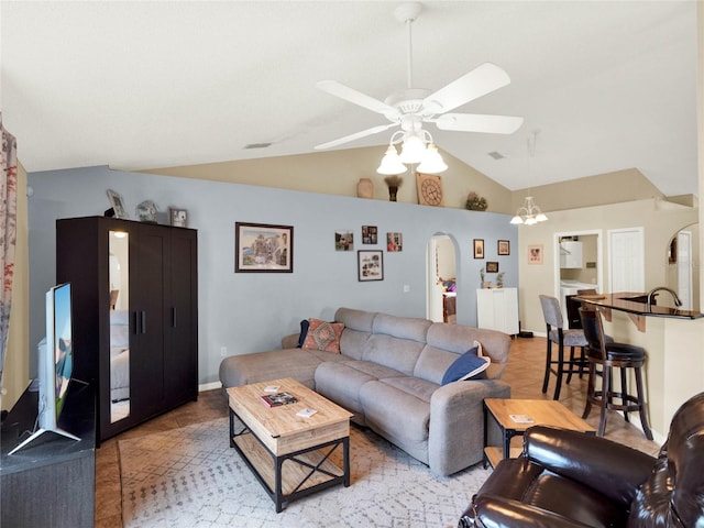 living room with light tile patterned flooring, lofted ceiling, sink, and ceiling fan