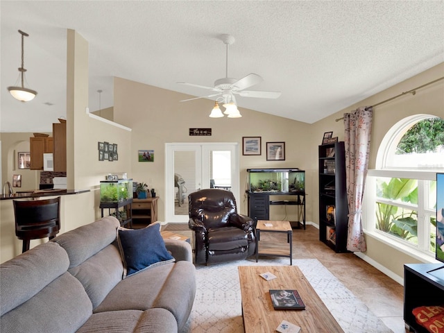 living room featuring french doors, ceiling fan, vaulted ceiling, and a textured ceiling