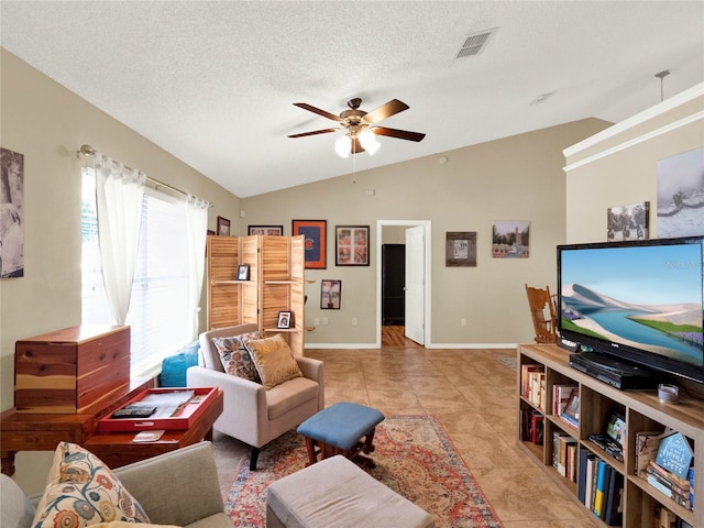 tiled living room with vaulted ceiling, ceiling fan, and a textured ceiling