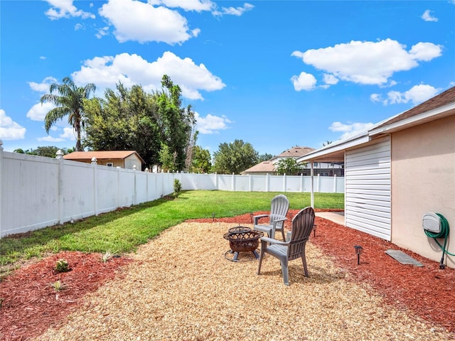 view of yard featuring an outdoor fire pit