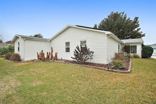 view of side of property featuring a yard