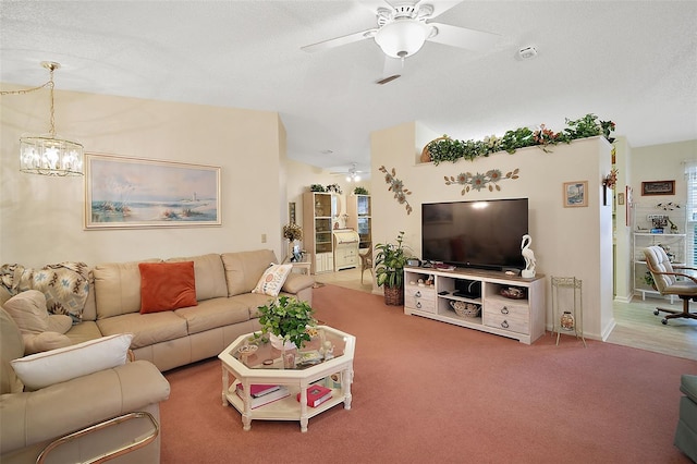 carpeted living room featuring ceiling fan and a textured ceiling