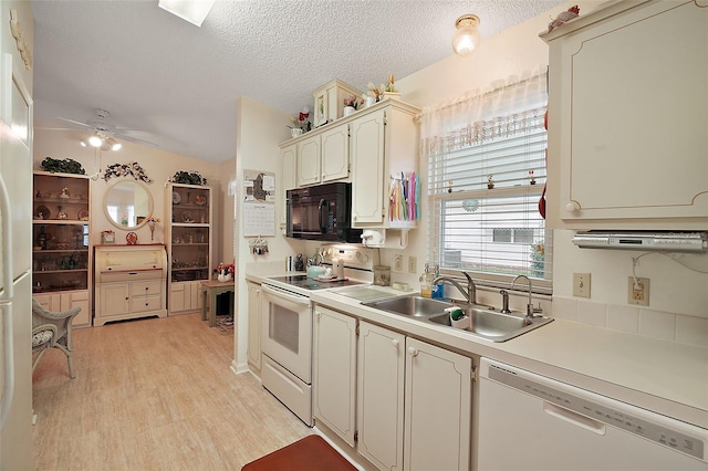 kitchen with sink, white appliances, ceiling fan, a textured ceiling, and light hardwood / wood-style flooring