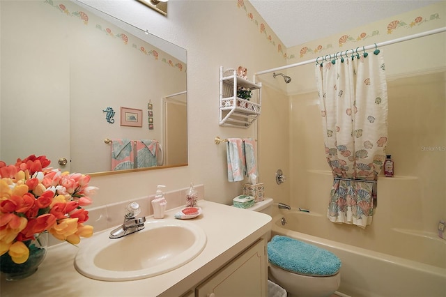 full bathroom with vanity, shower / tub combo with curtain, a textured ceiling, and toilet