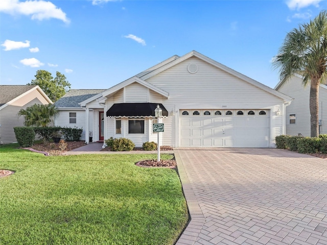 single story home featuring a garage and a front yard