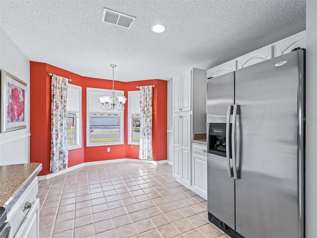 kitchen with light tile patterned floors, white cabinetry, a notable chandelier, stainless steel fridge with ice dispenser, and decorative light fixtures